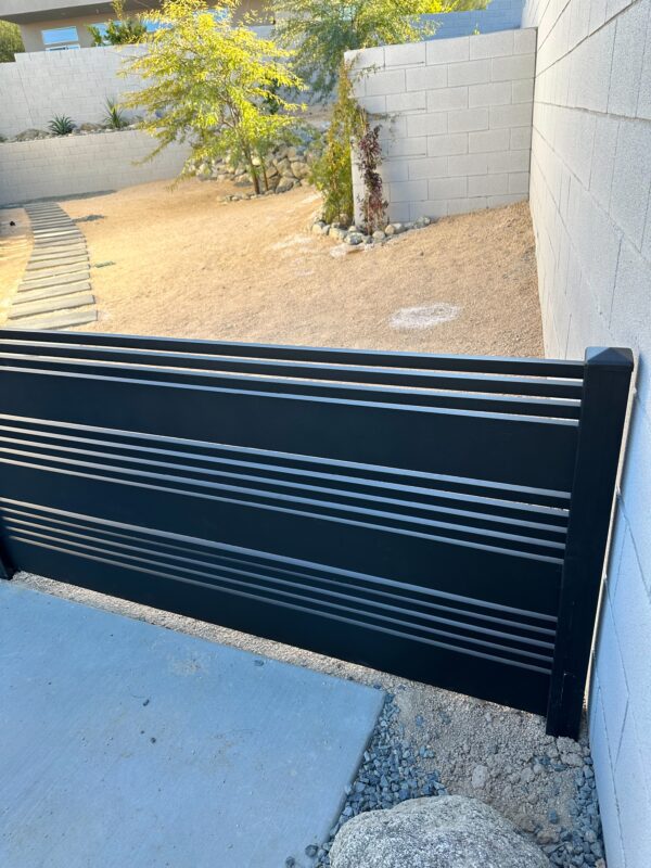 Aluminum gate with horizontal slats in a desert backyard setting in Cathedral City, CA.