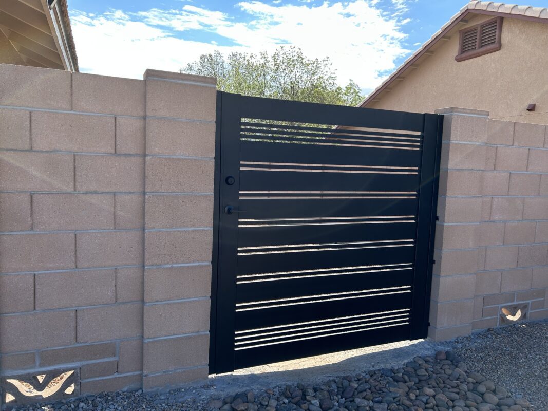 Modern matte black aluminum gate installed in Sierra Vista, AZ, with slat design.
