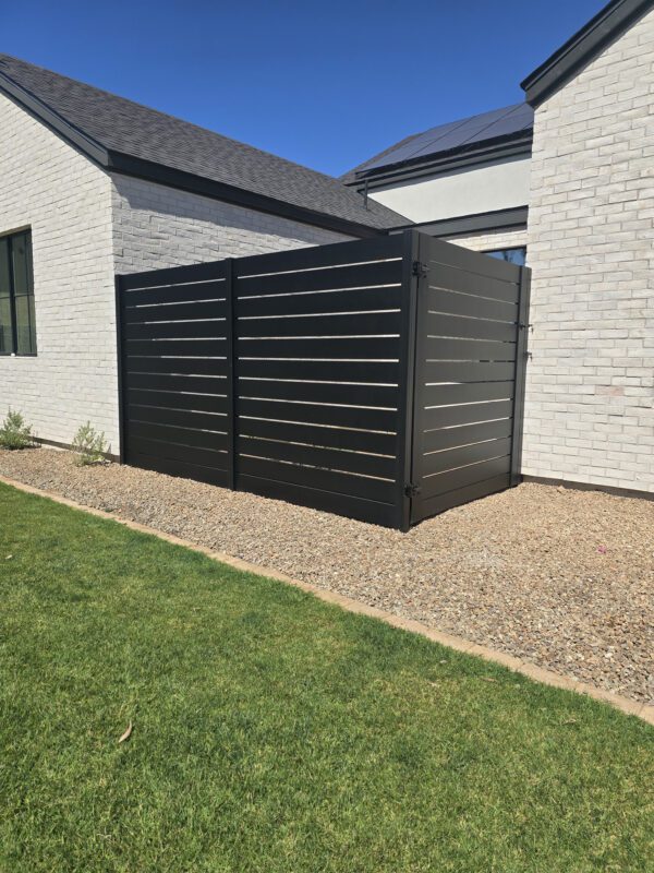 Modern aluminum privacy gate in satin black, enhancing backyard aesthetics and security.