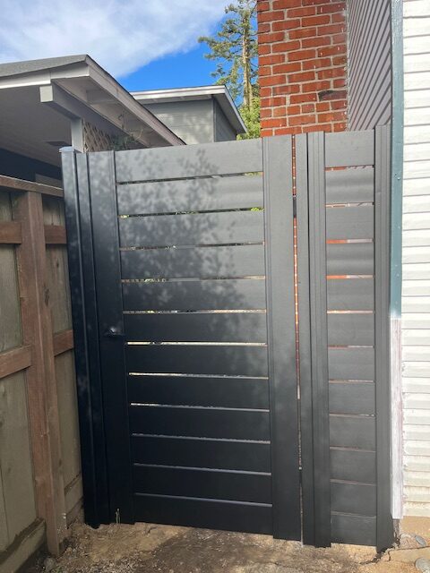 Black aluminum man gate installed, enhancing privacy and curb appeal in Oakland, CA.