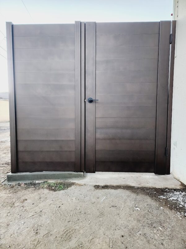 Modern bronze aluminum fence and gate installed in Oxnard, CA, enhancing privacy and security.