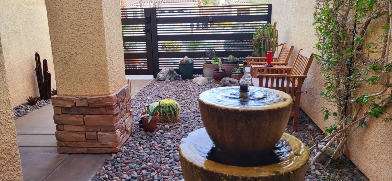 Modern aluminum fence with a sleek design in a landscaped garden setting.