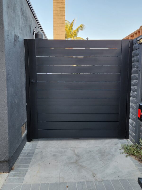 Matte black aluminum gate with horizontal slats installed for privacy.