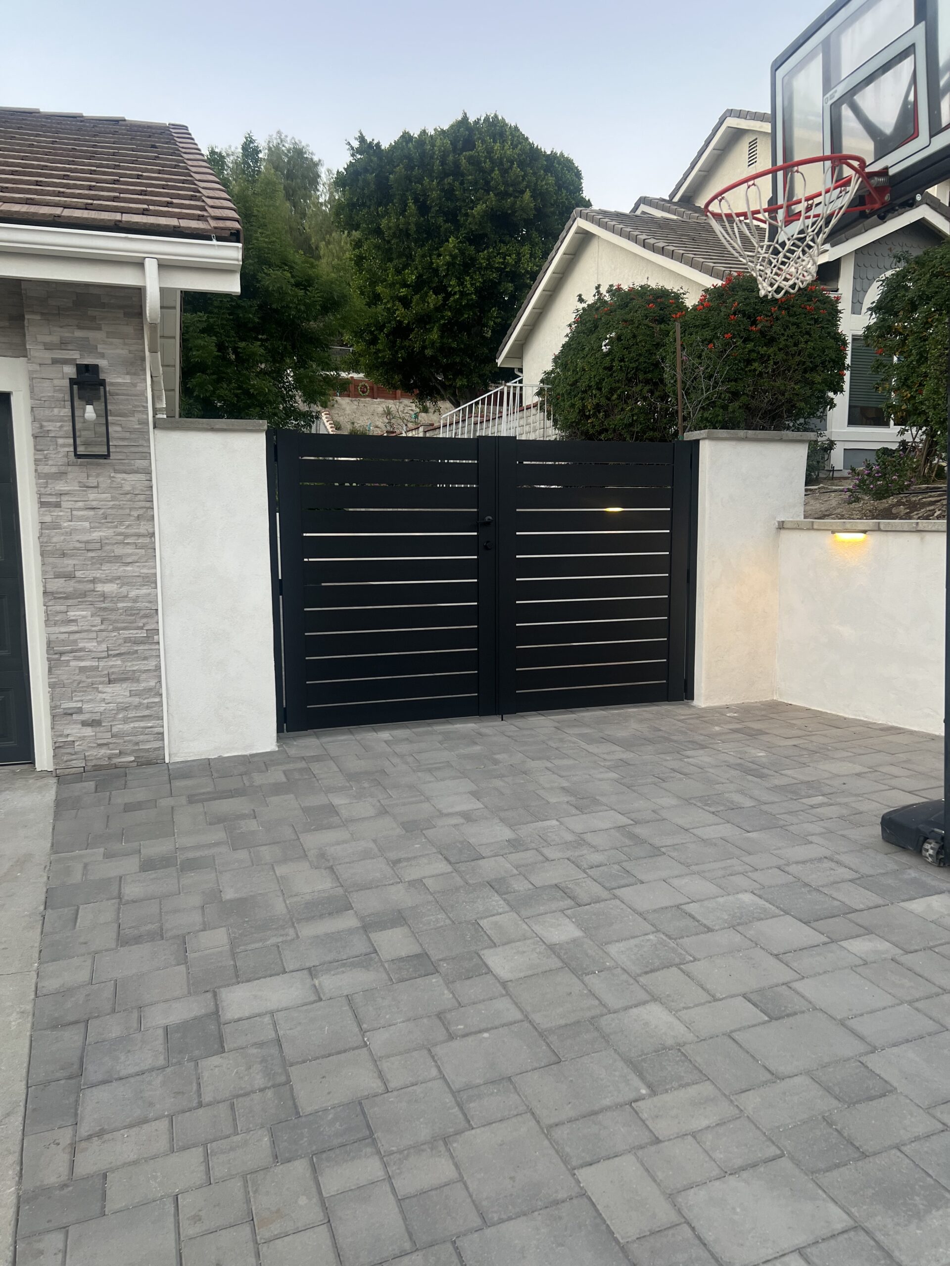 Aluminum gates with horizontal slats installed in a residential driveway in Granada Hills.