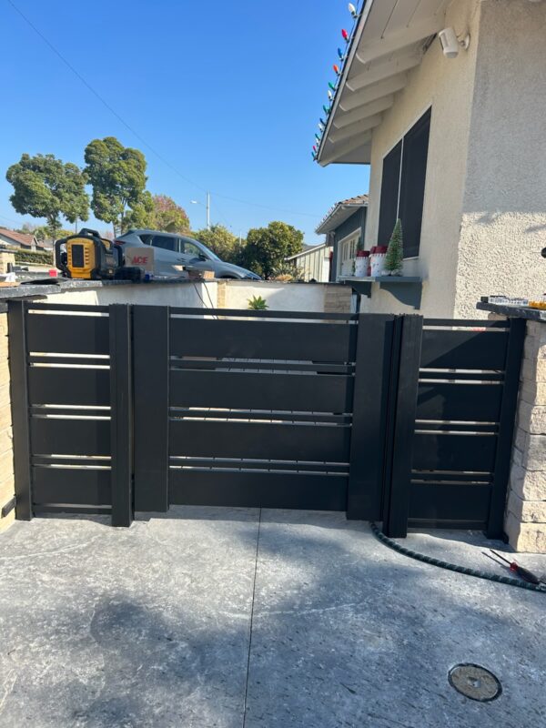 Black aluminum gate installation with modern design in Ventura, CA.