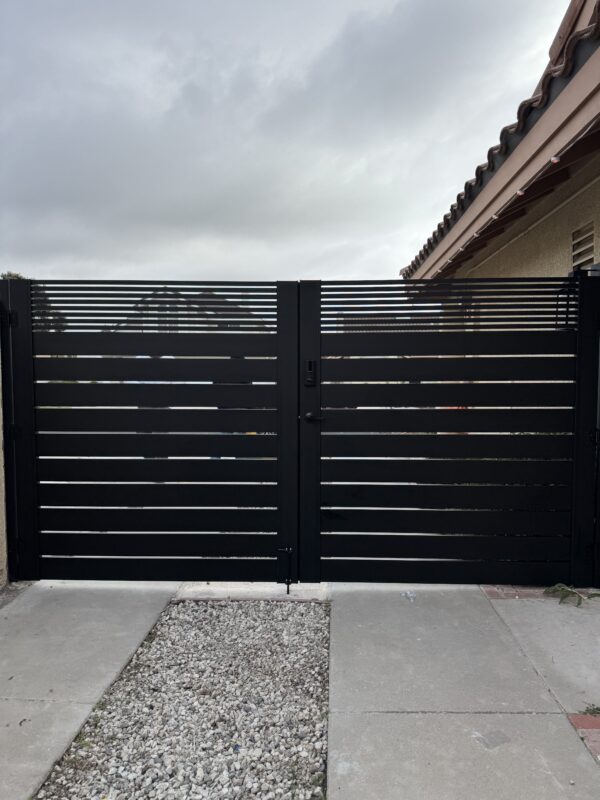 Modern matte black double swing gate with horizontal slats and sleek design.