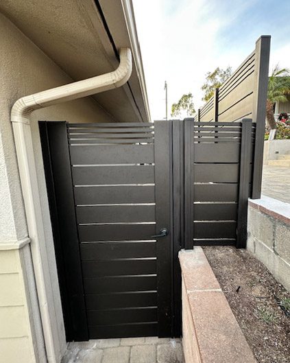 Bronze aluminum wall topper and gate installed in a residential setting in Ventura, CA.