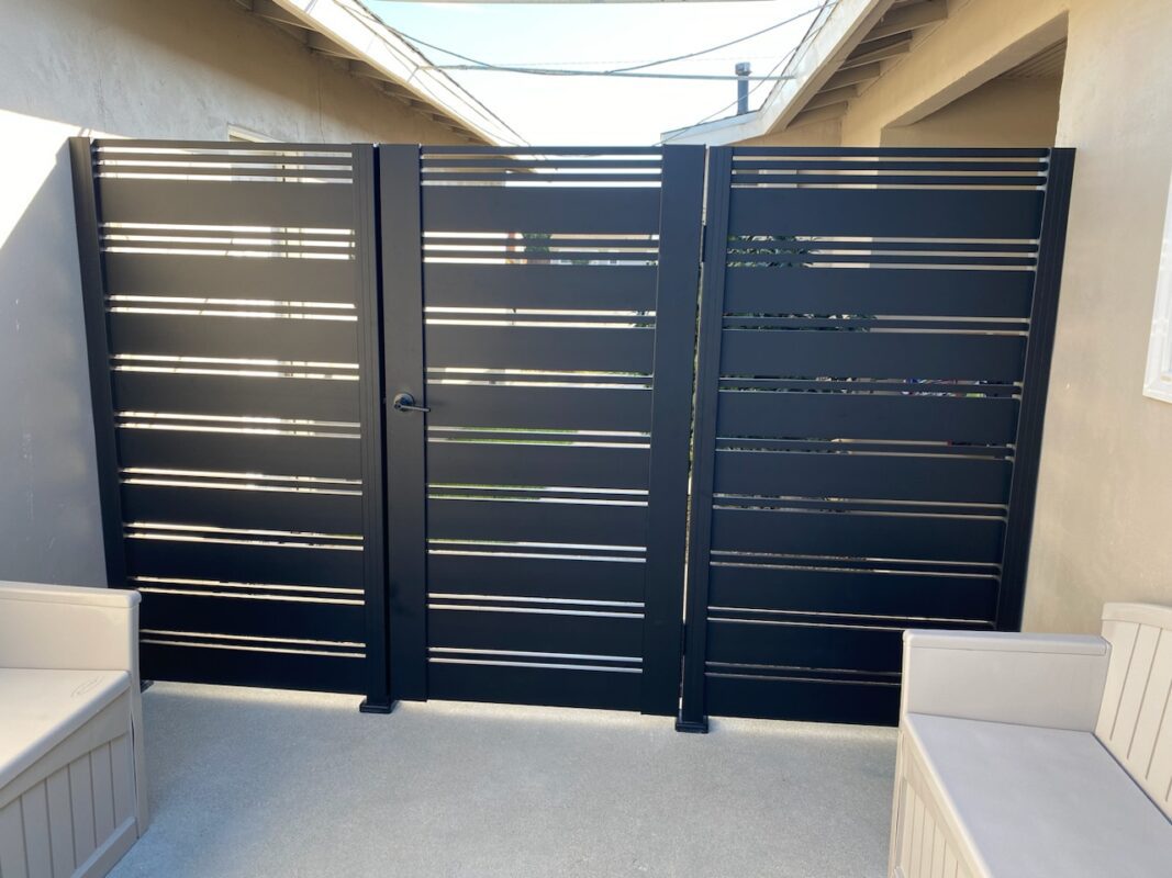 Modern black aluminum gate with side panels, ensuring privacy and style.