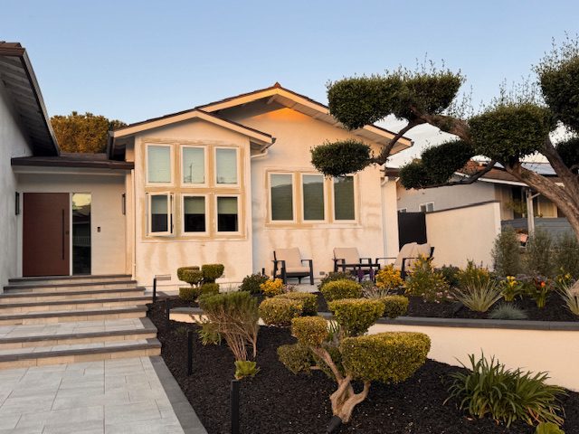 Fence installation featuring a matte black aluminum gate for a modern home.