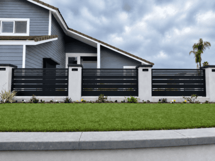 Black Dallas Style aluminum fence panel installed between masonry columns