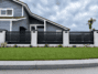 Black Dallas Style aluminum fence panel installed between masonry columns