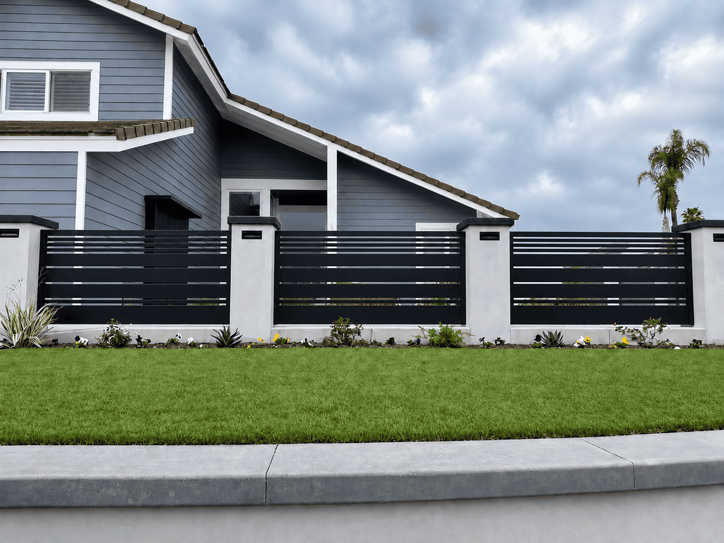 Black Dallas Style aluminum fence panel installed between masonry columns