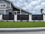 Black Miami Style aluminum fence panel installed between masonry columns
