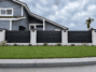 New York Style aluminum privacy fence between masonry columns in black