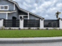 Black San Francisco Style aluminum fence panel installed between masonry columns