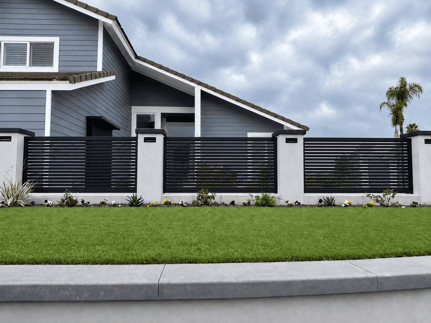 Black San Francisco Style aluminum fence panel installed between masonry columns