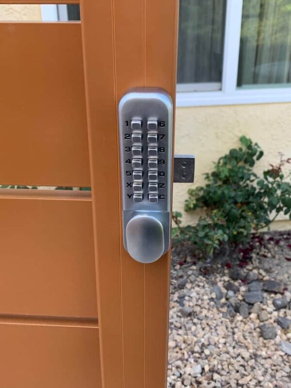 Brown Aluminum fence and pedestrian gate
