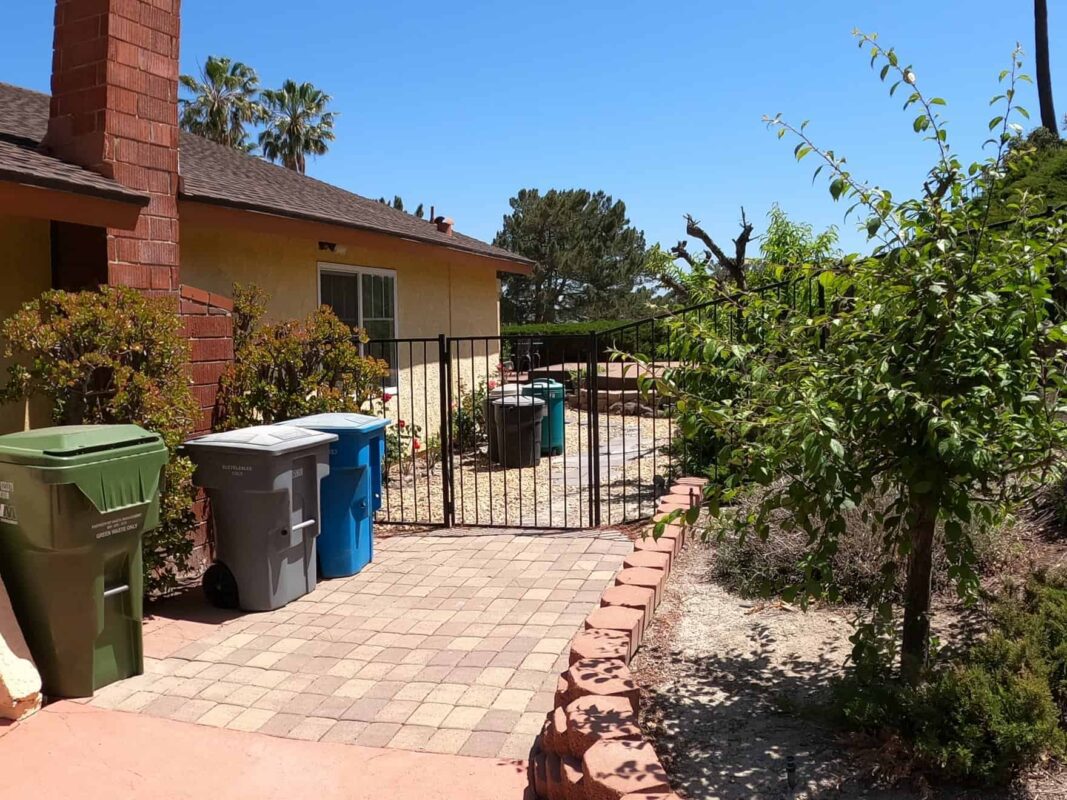 Brown Aluminum fence and pedestrian gate