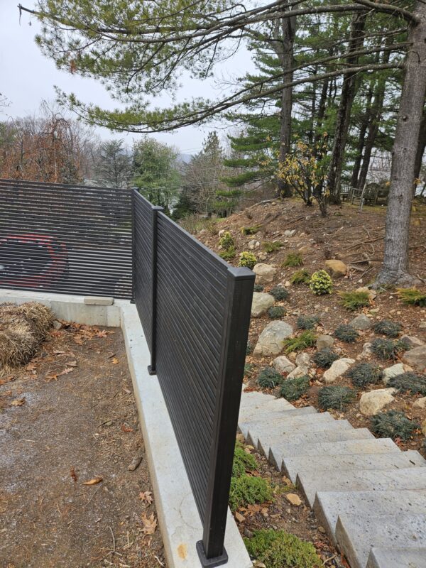 Corner section of black aluminum fence beside staircase