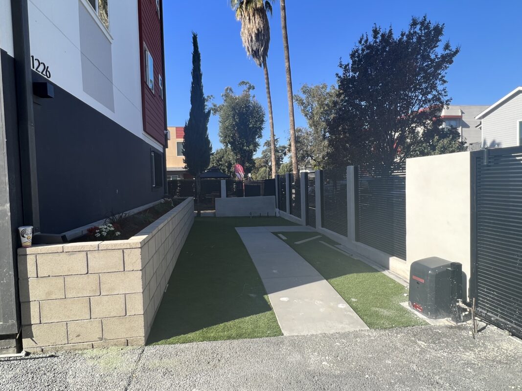 Side View of Yard with Alumission's San Francisco Style Driveway Gate, Pedestrian Gate, and Fence Panels.