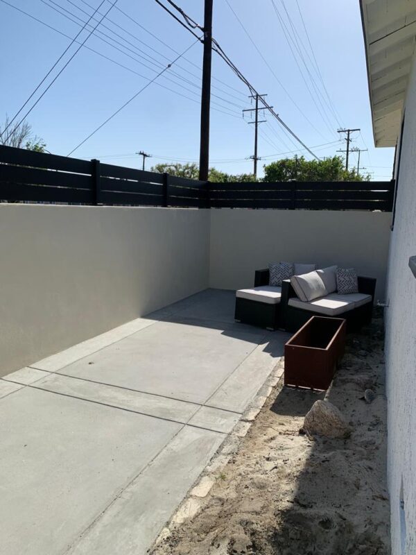 Fence installation with black aluminum toppers enhancing outdoor space.
