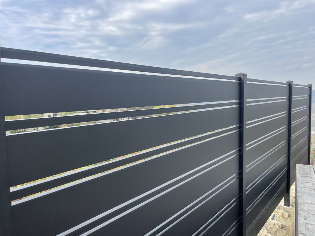 Black aluminum fence installation showcasing modern design and durability.
