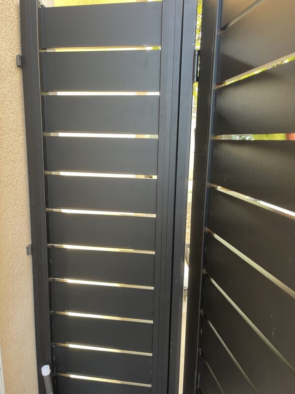Black aluminum side yard gate, modern design with sleek lines, enhancing property aesthetics.