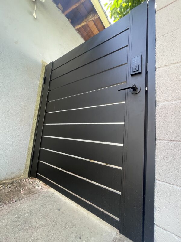 Modern black aluminum side gate with sleek design and keypad entrance.