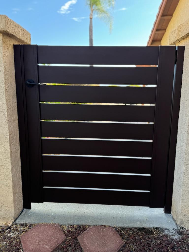Sleek bronze gate design with horizontal slats, enhancing security and elegance.