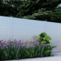 White New York Style Alumission aluminum fence kit installed in a landscaped yard