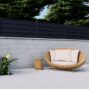 Black Miami Style Alumission aluminum wall topper kit installed above a modern patio wall