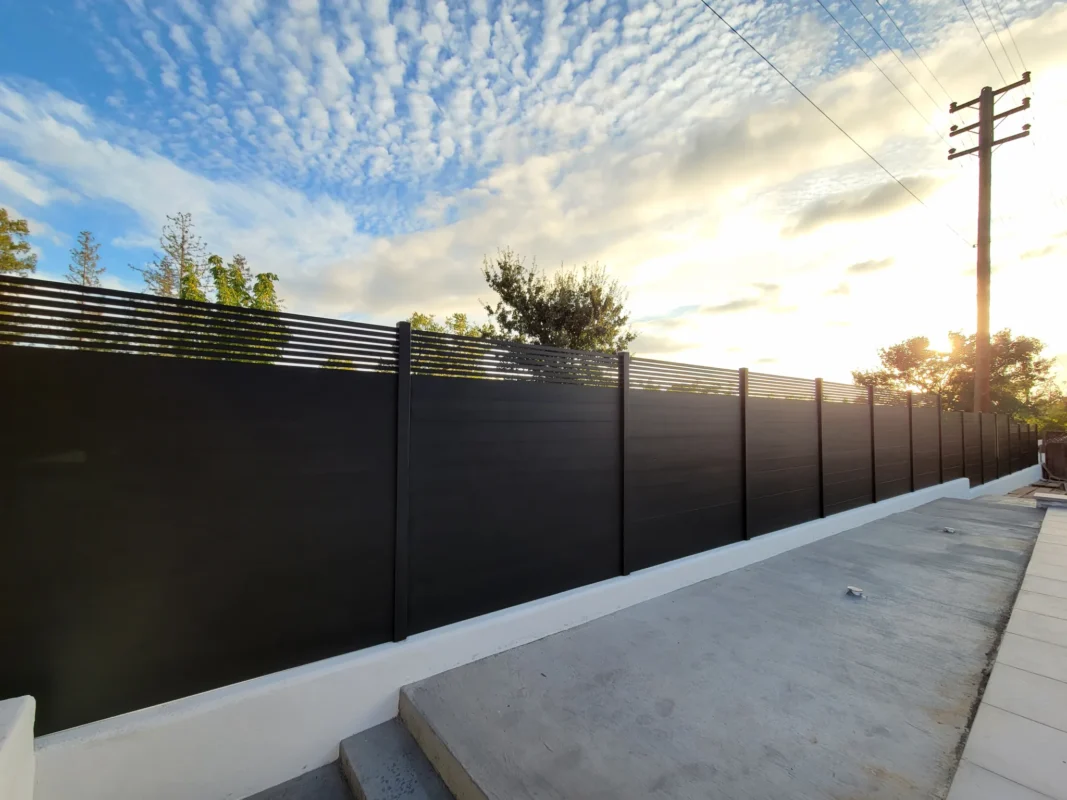 Black horizontal aluminum fence beside a concrete walkway in Walnut Creek.